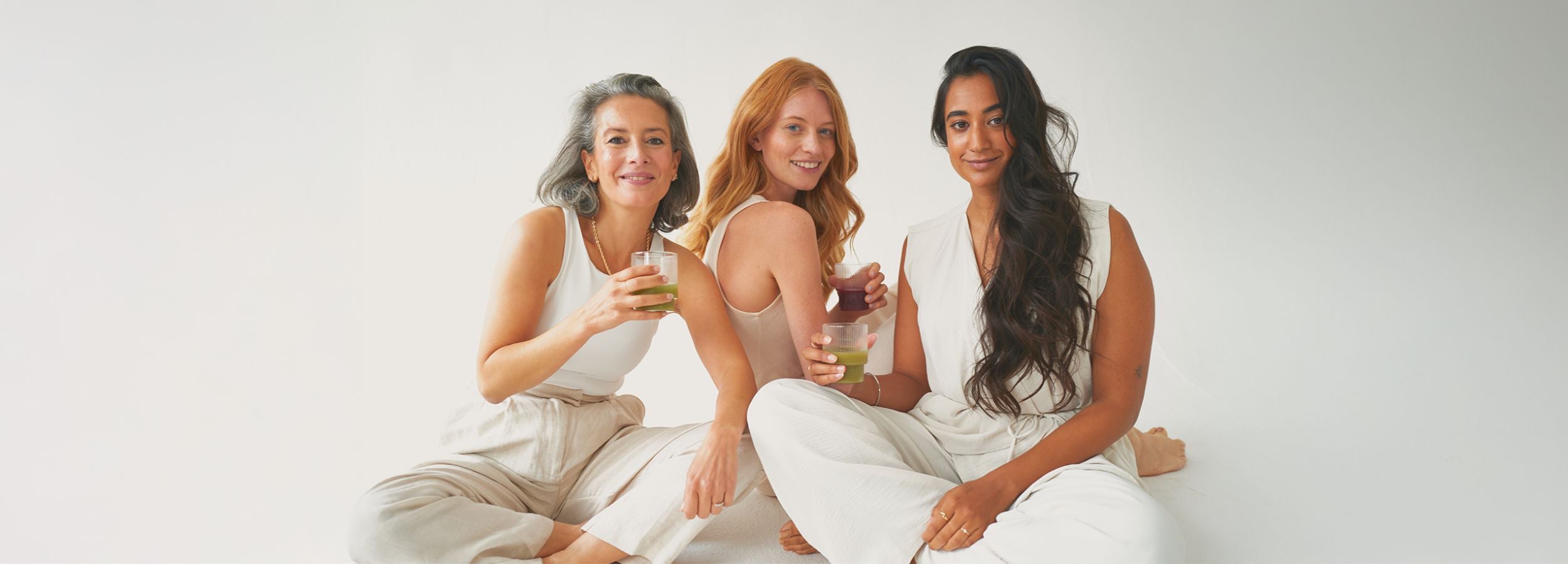 Drei Frauen mit Säften in der Hand